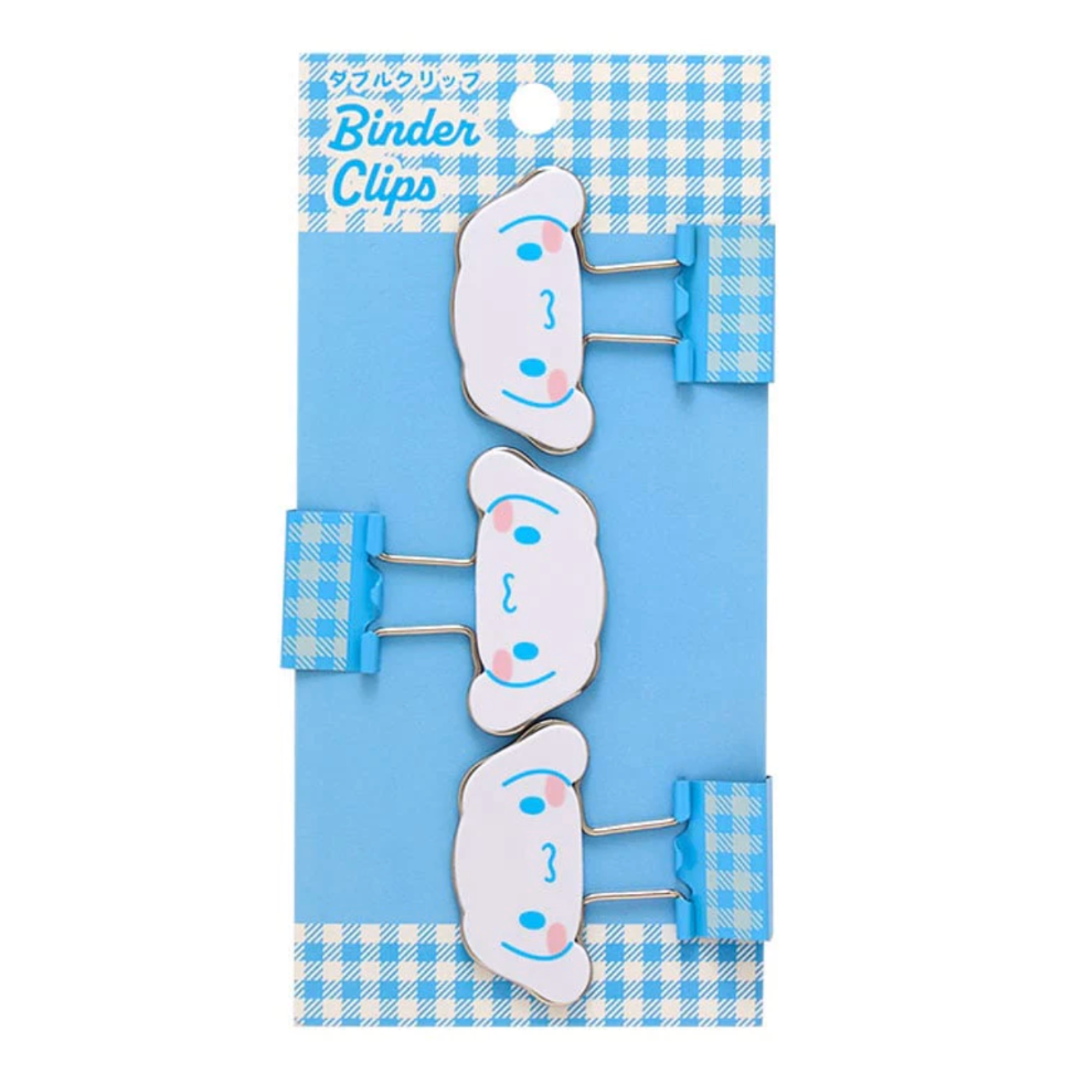 Set of cartoon-style binder clips on a blue and white checkered background