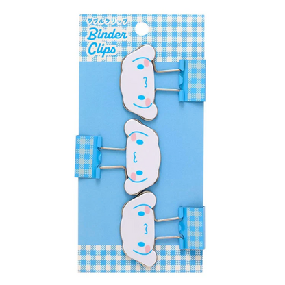 Set of cartoon-style binder clips on a blue and white checkered background