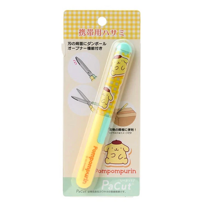 Small pair of scissors with a Pompompurin cartoon character on a yellow and white checkered background