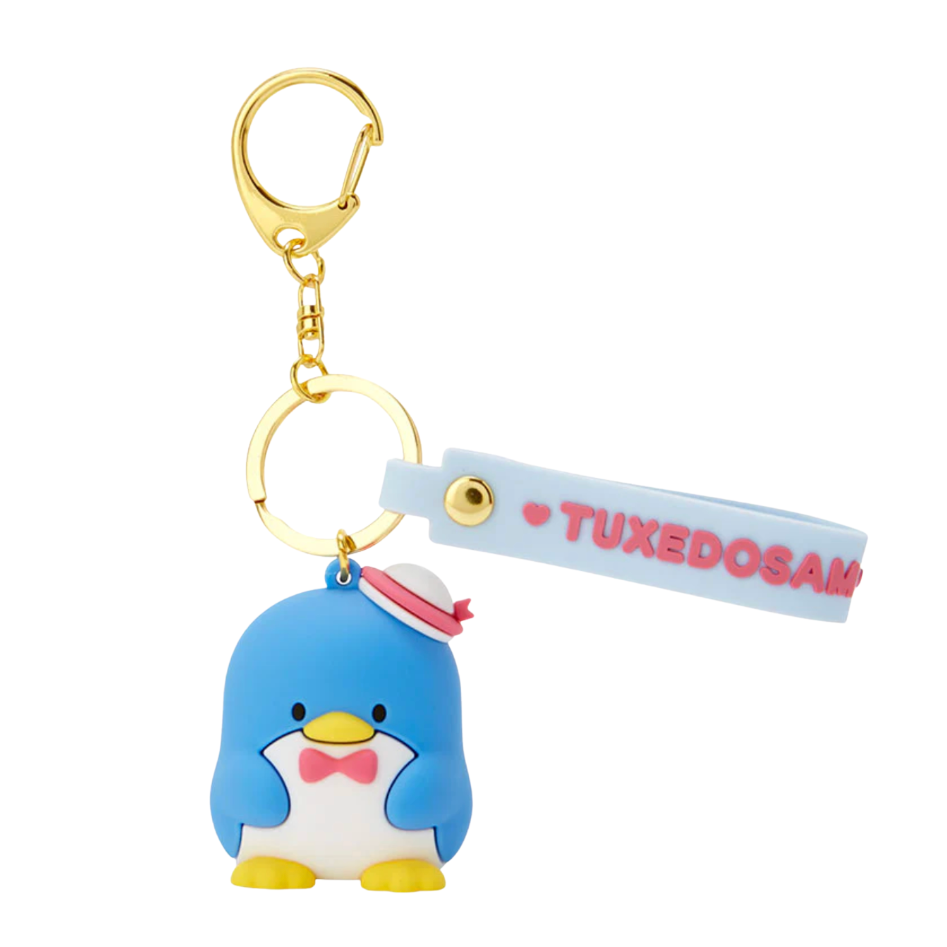 Penguin-shaped keychain with a gold ring and 'Tuxedosama' strap on a white background