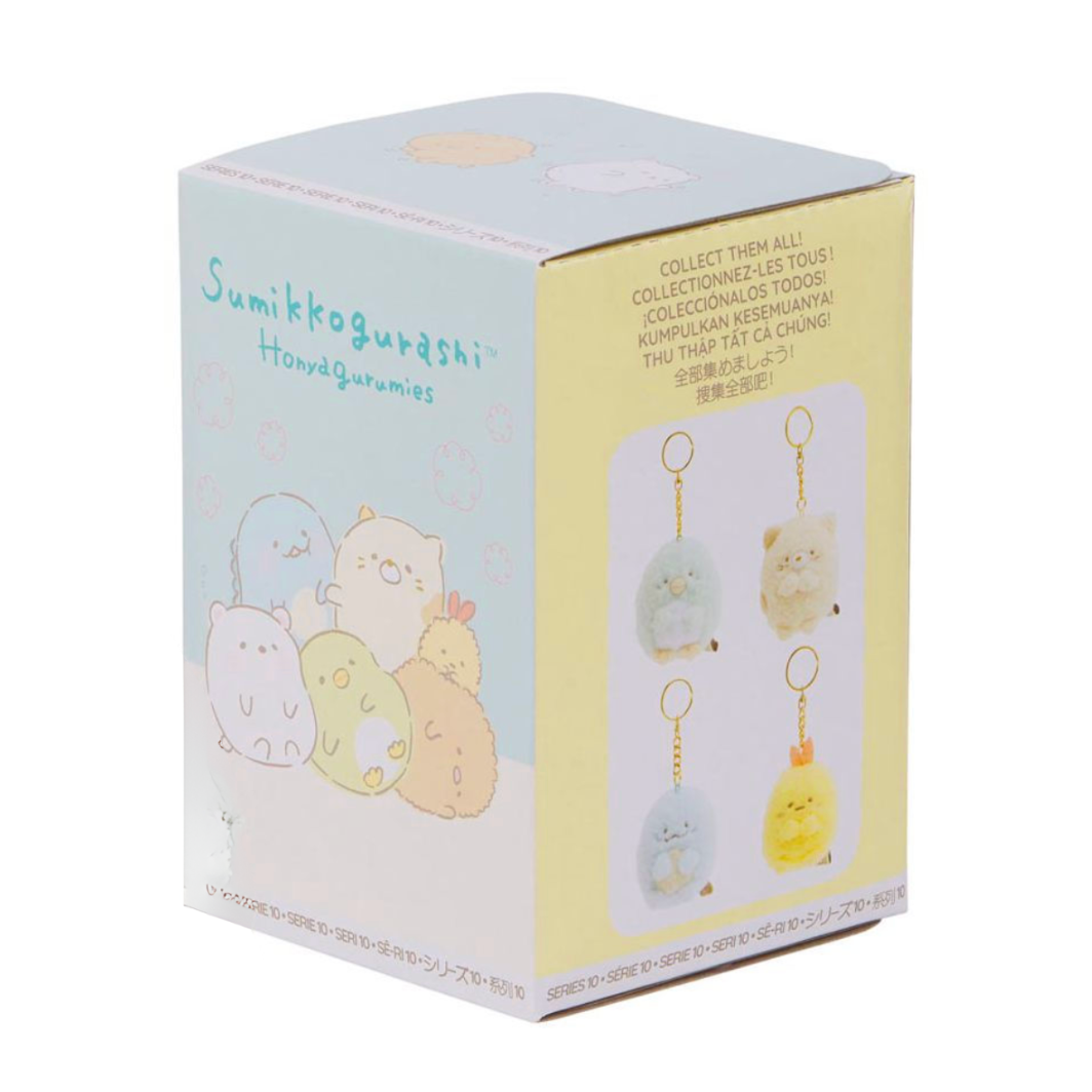 Box of Sumikkogurashi keychains with illustrations on a white background