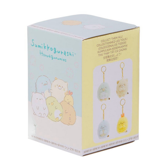 Box of Sumikkogurashi keychains with illustrations on a white background