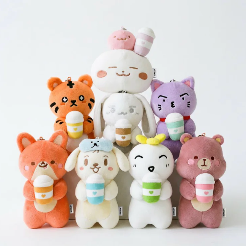 Stack of colorful plush toys with animal designs on a white background