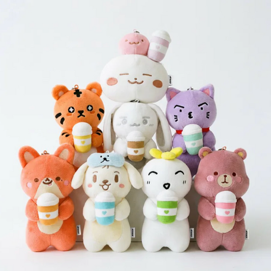 Stack of colorful plush toys with animal designs on a white background
