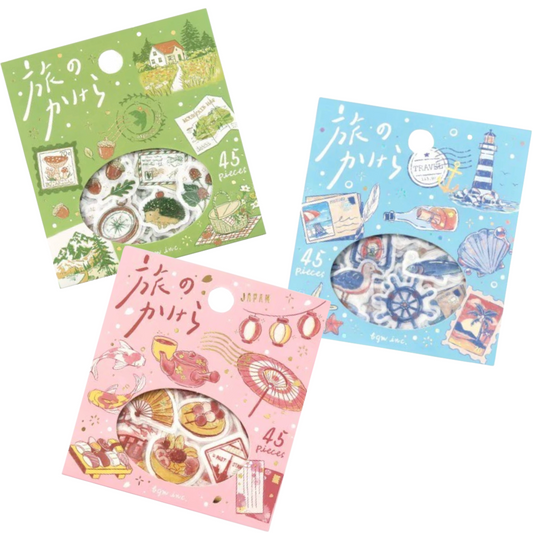 Three decorative sticker sheets in illustrated packaging, shown on a plain white background. The top-left sheet is green with a countryside scene and the text '45 pieces'; the bottom-left sheet is pink with Japanese lanterns and '45 pieces'; the right sheet is light blue with a lighthouse and '45 pieces'.