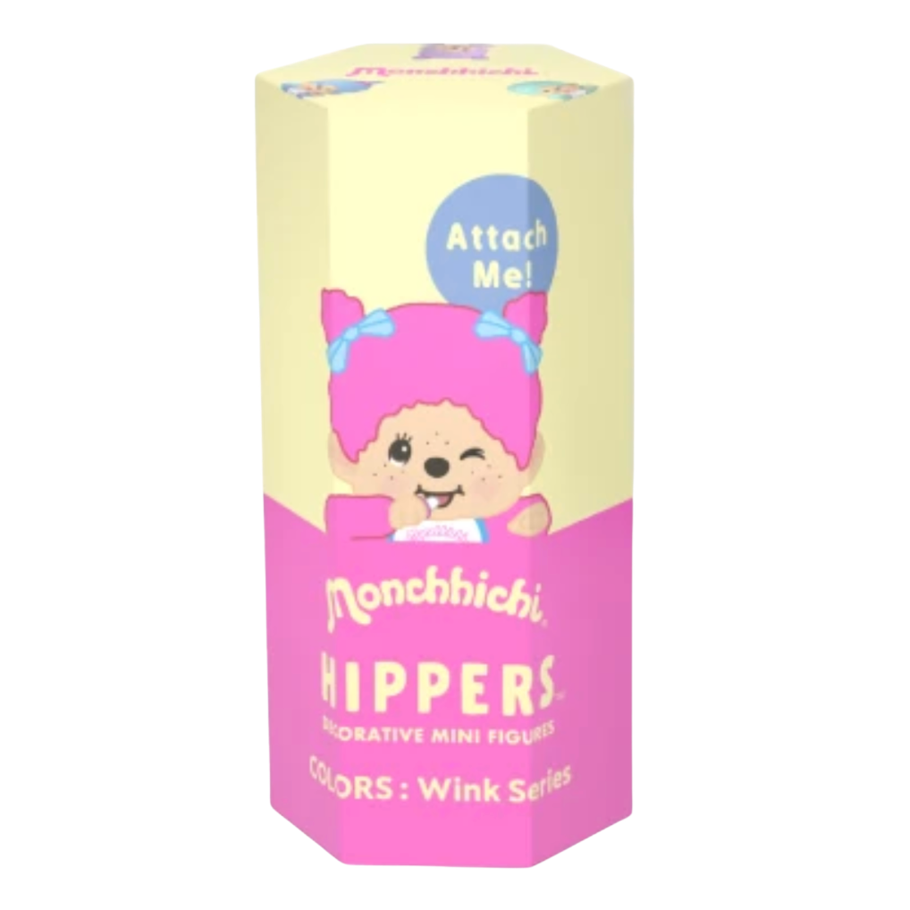 Monchhichi Hippers Wink Series decorative mini figures in a hexagonal box with a pastel yellow top half and pink bottom half, featuring a cartoon character and the text 'Attach Me!'.