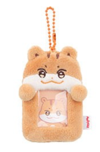 A plush hamster-shaped phone pouch or keychain holder with a clear window showing a cartoon hamster face inside, attached to an orange ball chain. The hamster is tan and white with embroidered facial features, set against a plain white background.