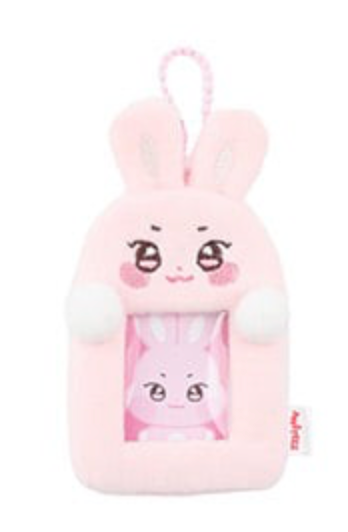 A pink plush bunny-shaped phone case or card holder with a cartoon face, a hanging loop at the top, and a clear window showing a smaller bunny illustration inside.