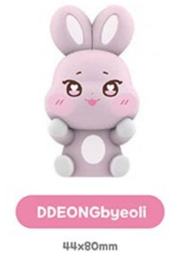A cute pink bunny-shaped product with large ears, cartoon eyes, and a smiling face, shown on a white background with a pink label reading 'DDEONGbyeoli' and size text '44x80mm'.