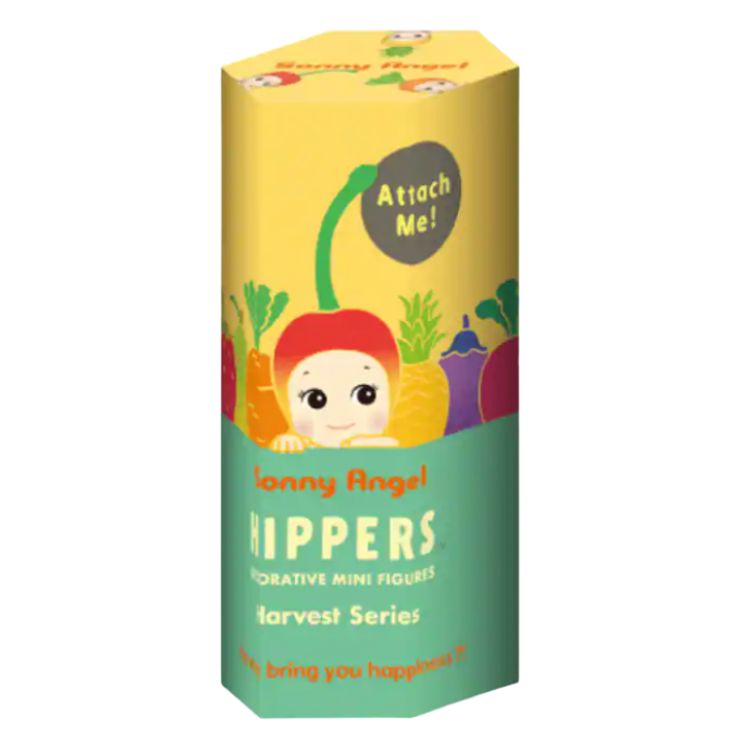 A tall, narrow cardboard box for 'Sonny Angel Hippers' from the 'harvest Series', featuring a yellow top half with a cartoon character peeking out, and a green bottom half with the product name in white text.