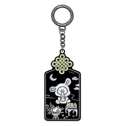A black enamel keychain featuring a cartoon rabbit sitting with a crescent moon, clouds, and a gold-toned Chinese knot at the top, attached to a silver metal ring.