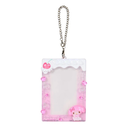 A pink My Melody-themed plastic ID badge holder with a silver chain strap, featuring a white top border, pink heart accents, and a 3D pink My Melody character at the bottom right.
