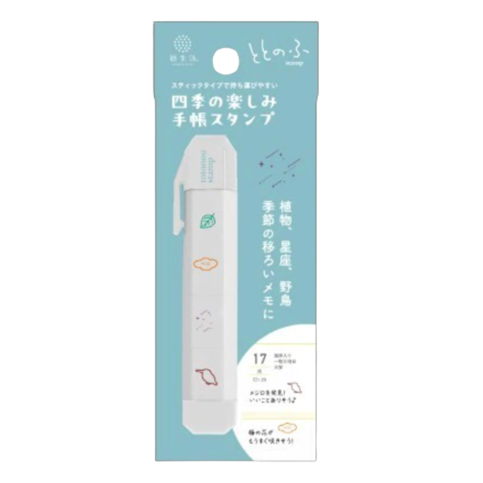 A package of a handheld seasonal flower stamp tool shown upright on a plain white background. The package is light blue and white with Japanese text and a small illustration of the device.