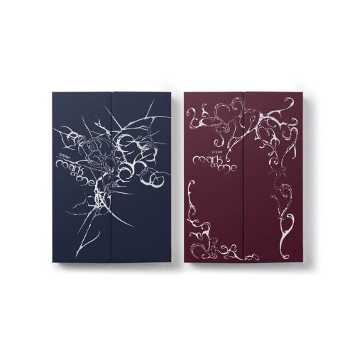 Two slim hardcover albums shown side by side on a light gray background. The left one has a dark navy cover with white abstract line art and the title 'Mark on Me'. The right one is maroon with white abstract line art and the title 'Mark on Me' on a white background.