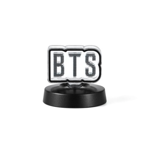 BTS logo on a black stand with a white background