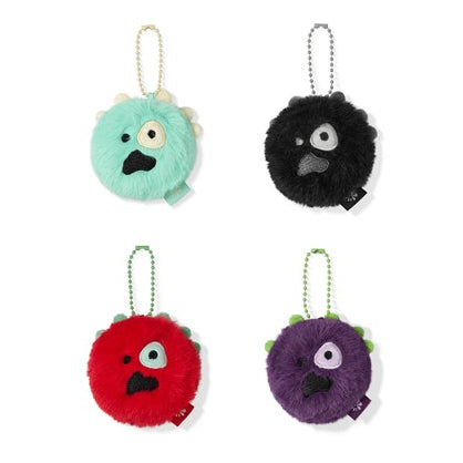 Four round plush monster keychains arranged in a 2x2 grid on a white background. The top-left keychain is mint green with a gold chain, the top-right is black with a silver chain, the bottom-left is red with a green chain, and the bottom-right is purple with a green chain.