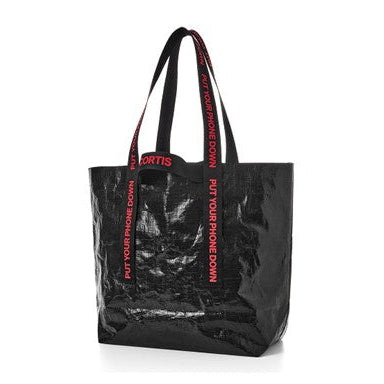 A black glossy tote bag with red text on the handles and sides reading 'PUT YOUR PHONE DOWN' and 'FORGETS', shown on a plain white background.