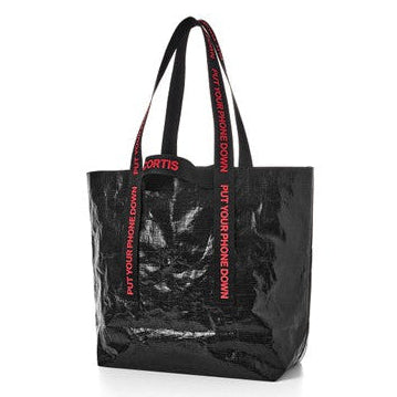 A black glossy tote bag with red text on the handles and sides reading 'PUT YOUR PHONE DOWN' and 'FORGETS', shown on a plain white background.