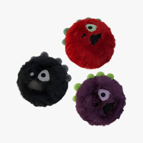 Three fuzzy monster toys in red, black, and purple on a white background